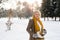 Senior woman in winter nature going ice skating.