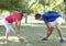 Senior Woman Working With Personal Trainer In Park