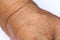 Senior woman wrinkled wrist of the arm on white background, Close up