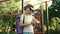 Senior woman with yoga mat stands on street gym and uses sports watch. An elderly woman holding a yoga pad and checking