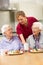 Senior women with carer enjoying meal at home