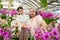 Senior women with daugther choosing orchids in a large store.