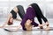 Senior women doing Revolved Downward-facing dog pose