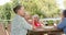 Senior women enjoy a meal outdoors