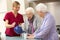 Senior women at home with carer