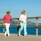 Senior women jogging together outdoors.