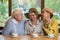 Senior women laughing at table.