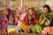 Senior women perform puja - ritual ceremony at holy Pushkar Sarovar lake,India