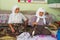 Senior women spin wool for carpet production in Karacahisar, Turkey.