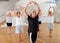 Senior women in sportswear dancing ballet inside gym