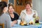 Senior women talking with girl while tea drinking