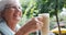 Senior women toasting coffee cup and a mug in the cafe 4k