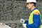 Senior worker checks the correctness of the work on the construction site