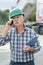 Senior workman outdoors speaking on telephone