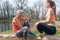 Senior and young woman resting on log after sport