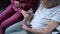 Seniore woman and her mature daughter play with a cute Scottish Straight-Eared kitten at home on the couch. The topic of