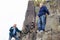 Seniors and child trekking on the rock