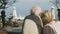 Seniors couple looking at the sea while sitting in the cafe on the street