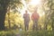 Seniors couple in sports clothing jogging together in par