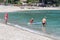 Seniors enjoying beach based leisure activities in the sea off Agios Ioannis beach, Lefkada, Greece