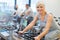 Seniors on exercise bikes in spinning class at gym