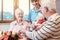 Seniors in nursing home exchanging presents for Christmas