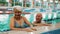 Seniors at a pool. Portrait of two caucasian pensioners - a woman and a man - looking at camera while standing near the