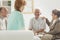 Seniors sitting with nurse