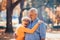 Seniors on a walk in autumn forest