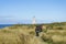 Seniors walking away and towards Waipapa Point lighthouse