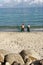 Sennon Cove Cornwall England. Two men casting a fishing net from the beach