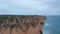 Sensational aerial drone view flying above Lagos Portugal coastline, cloudy day, flying forward