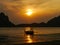 Sensational golden sunset over the beautiful Pak Meng beach with a traditional Thai Long-tail boat