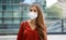 Sense of bewilderment. Young woman in empty city street wearing protective mask. Girl with face mask feeling alone during a