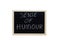 SENSE OF HUMOUR written with white chalk on blackboard