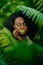 Sensitive outdoor portrait of the attractive african girl with green lipstick and eyeshadows gently touching her face