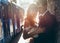 Sensitive portrait of the happy newlywed couple hugging and leaning on the wall at the background of the driving tram