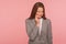 Sensitive teeth. Portrait of unhealthy young woman in business suit touching her cheek, frowning