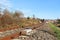 Sensor signaling the passage of the train on the railway track to activate the alarm at a road crossing. Mound of coarse gravel