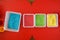 Sensory bin for toddlers with colourful rice on red table. Universal educational game