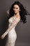 Sensual asian woman with long dark hair in elegant lace dress