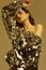 Sensual beautiful brunette woman in a shiny fashion dress of sequins
