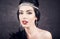 Sensual brunette closeup with twenties retro look on black glow