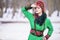 Sensual Caucasian Blond Girl in Fashionable Green Dress and Kokoshnik with Flowery Pattern and Beads. Posing In Winter Snowy Park