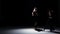 Sensual contemporary dance performance of four dancers on black, shadow