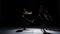 Sensual contemporary dance performance of three dancers on black, shadow