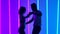 Sensual couple dancing salsa in the studio against the backdrop of pink and blue neon lights. The concept of love
