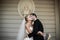 Sensual, happy newlywed valentynes hugging, wall with bust background