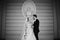 Sensual, happy newlywed valentynes hugging, wall with bust background b&w