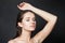 Sensual lady brunette portrait. Wellness model woman with healthy skin posing on black studio wall background